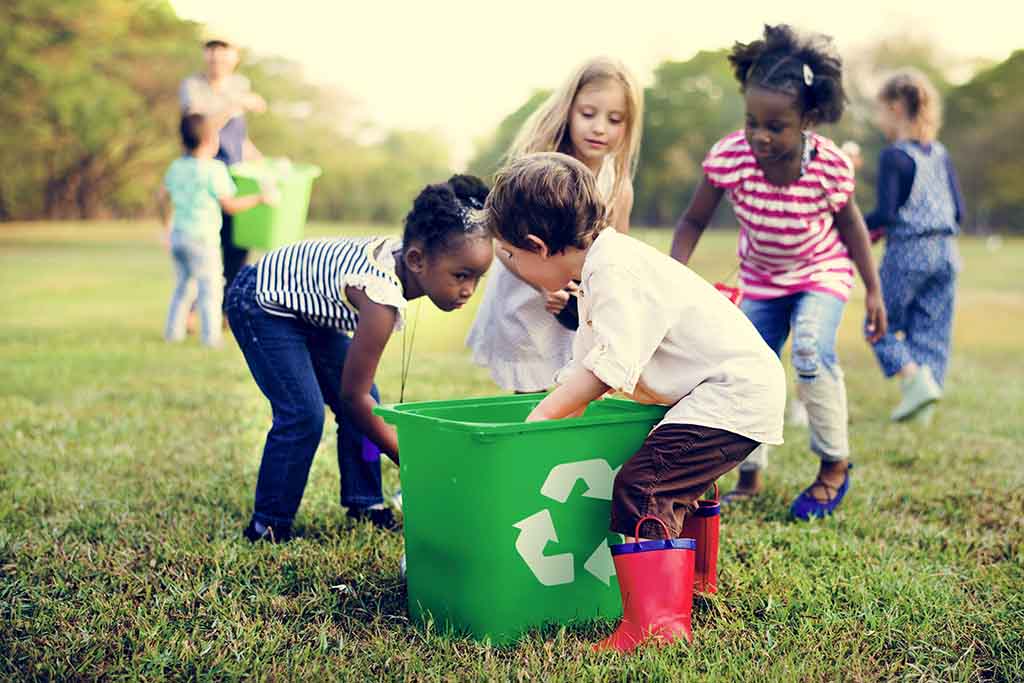 Kids filling a recycling bin