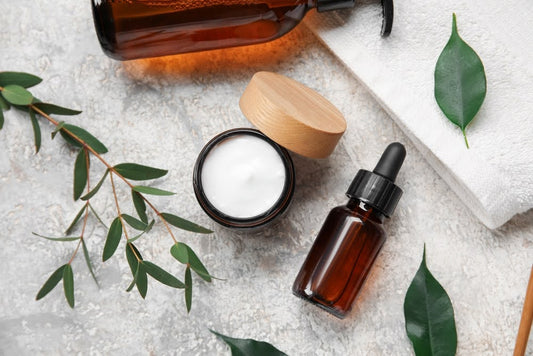 Clean beauty products—natural oil, soap, face cream, and a towel displayed together.