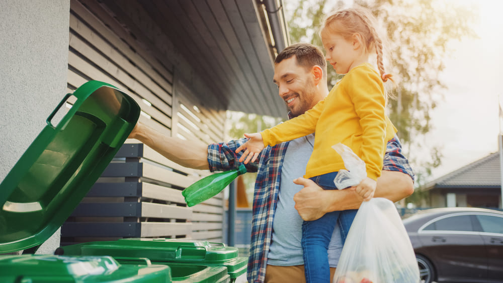 A father and daughter sort recyclables together to better care for the environment